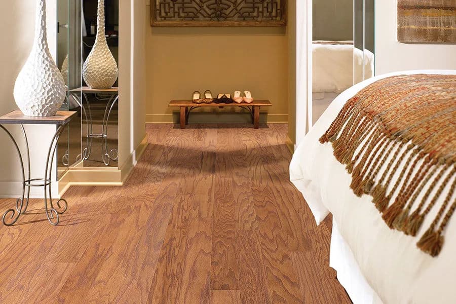 Elegant hardwood flooring in a stylish hallway leading to a bedroom with decorative accents.
