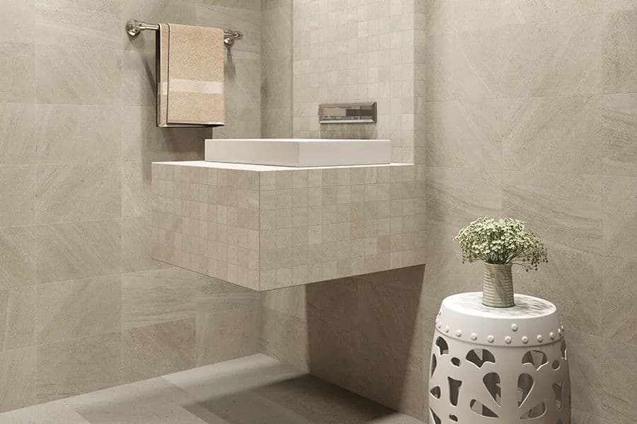 Modern bathroom design featuring a floating sink, tiled walls, and a decorative side table.